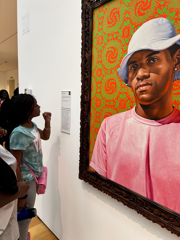 Students view a painting at the art museum